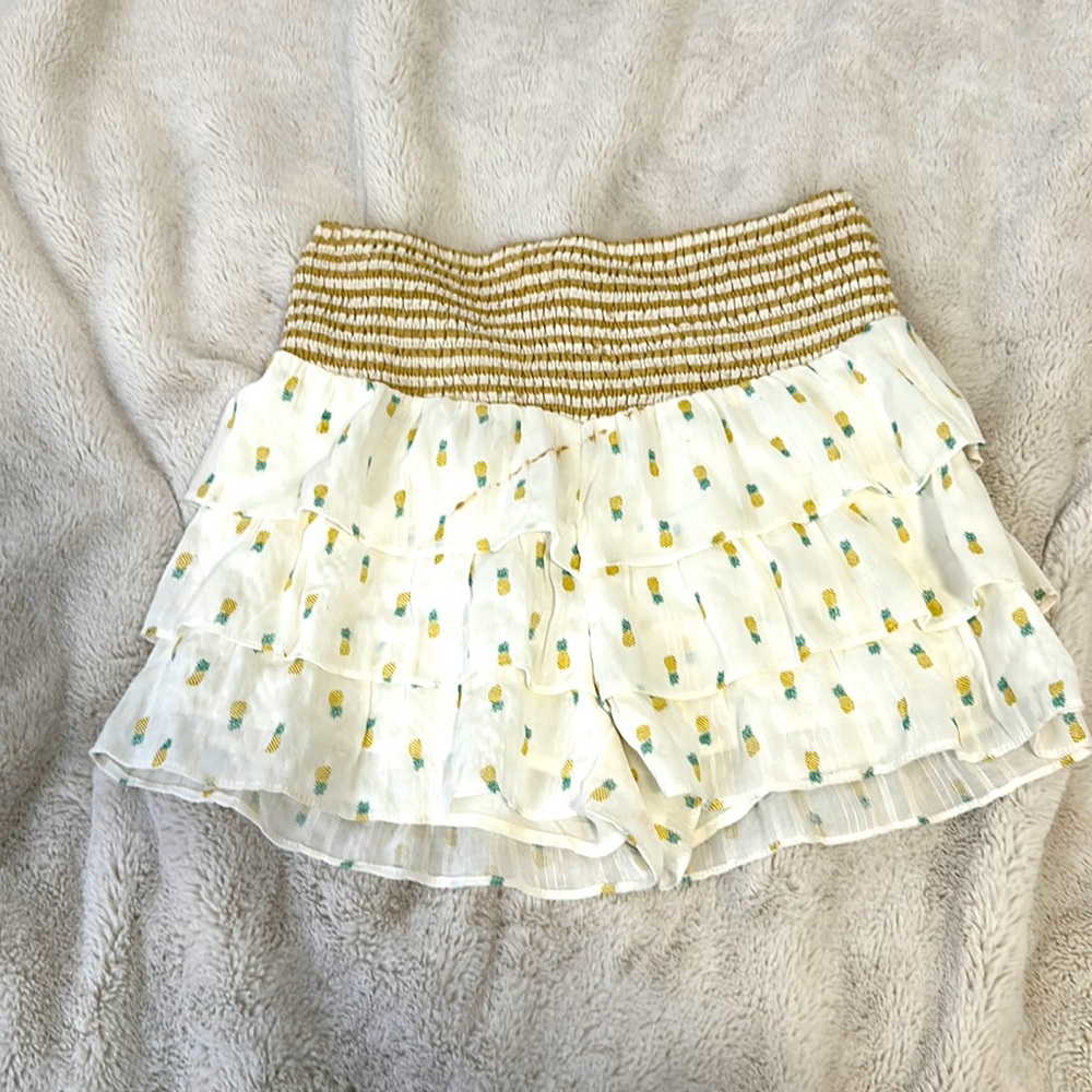 Cute skort with gold and white stripes with pineapples on it very cute